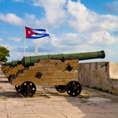 Old cannons with waving Cuban flag 