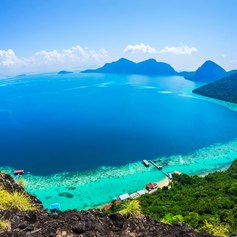 Green Malaysian coastline with hills and beautiful blue sea