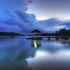 Peaceful scenery of jetty with beautiful cumulous clouds in the background 