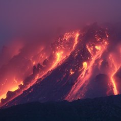 Volcano erupting at night 