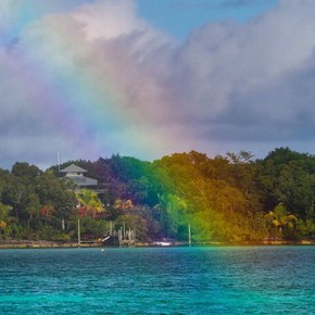 Rainbow across Manjack Cay's lush vegetation