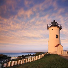 A white lighthouse overlooking the sea in New England
