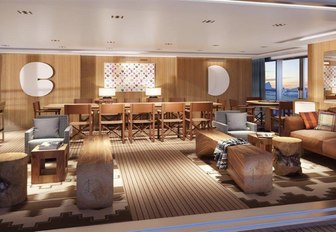 dining and seating areas in the wood-clad main salon aboard superyacht Planet Nine