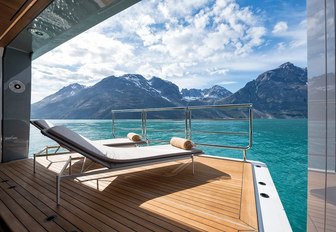 Sun loungers looking out across the water from a retractable balcony on board superyacht CLOUDBREAK