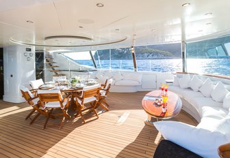 al fresco dining area and seating in the aft cockpit aboard luxury yacht Q