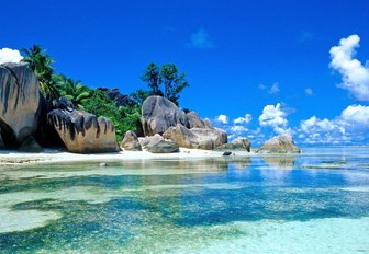 idyllic beach of the seychelles with boulders, white sands and clear waters