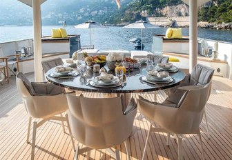 circular alfresco dining table on the main deck aft of expedition yacht ZULU 