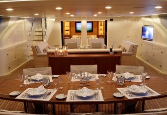 dining table and comfortable lounge area in the sunken aft cockpit aboard luxury yacht FIDELIS 