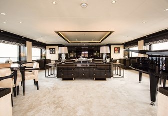 luxe salon with grand piano on board charter yacht Elixir