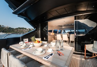 Outdoor dining area looking inside on charter yacht NEOPRENE