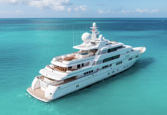 superyacht Titania sailing over calm turquoise ocean 