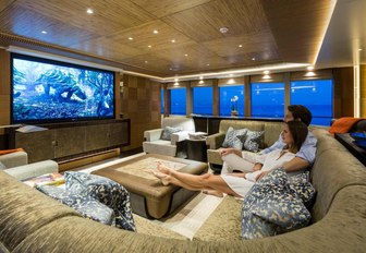 charter guests watch a movie in the media room aboard luxury yacht RUYA 