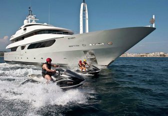 Guests on water toys with superyacht RARITY behind