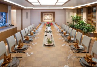 Large dining table arrangement set for a meal onboard superyacht charter FLYING FOX