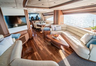 chess yacht main salon, with large tv screen and sofas with coffee table