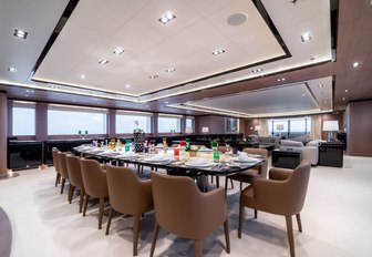 oval dining table in the main salon of motor yacht O’PTASIA 