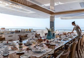 Tables set on outdoor deck of Superyacht LANA 