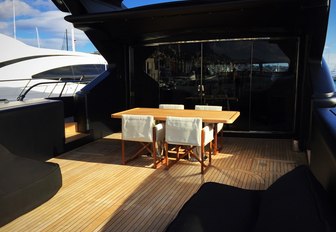 Small table with chairs on charter yacht NEOPRENE