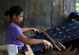 local Ngada woman hand-crafting ikat weavings