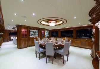 round table in the formal dining area in the main salon aboard superyacht Far From It 