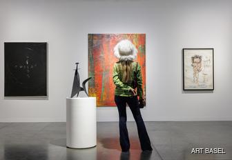 Art Basel Miami exhibit with charter guest viewing painting