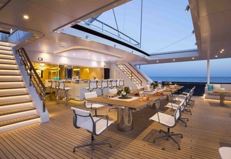 dining and indoor-outdoor bar on aft deck of superyacht AQUIJO