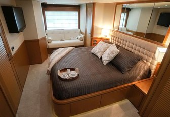 bright and spacious master suite with mirror and flat screen TV on luxury charter yacht NOMADA 