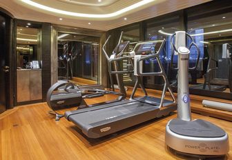 Gym equipment arranged in a dedicated gym with full height windows onboard charter yacht WHISPER