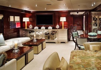 laid-back skylounge with seating, bar and games table on board superyacht Lady Joy