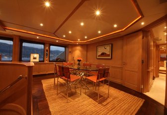 glass table and leather chairs in the interior dining area on board charter yacht ‘African Queen’ 