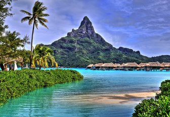 luxe over-water bungalows in Bora Bora against mountain backdrop