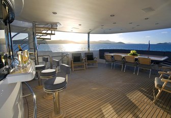 bar and dining table on the upper deck aft of motor yacht De Lisle III