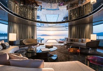 curved sofas and luxe styling in the main salon aboard charter yacht Savannah