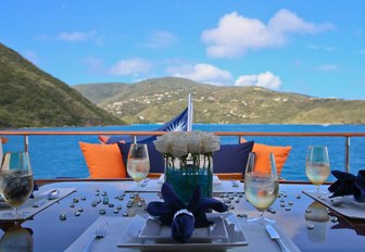 al fresco dining table on the sundeck of motor yacht M4 with views of the Bahamas