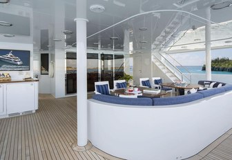 aft deck seating area with navy blue upholstery on board charter yacht Time For Us 