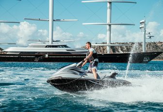 jet-ski riding alongside yacht