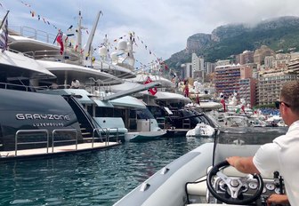 A crew member tendering in guests to a yacht at the Port Hercules