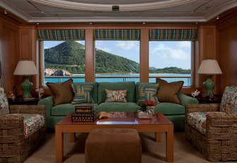 comfy seating in green fabrics aboard luxury yacht OASIS