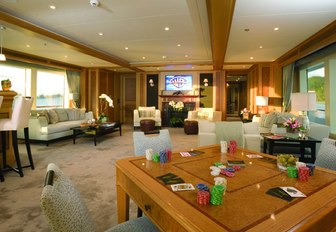 skylounge with sofas, bar and games table on board motor yacht UTOPIA 