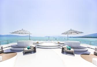 two Jacuzzis surrounded by sunpads on the sundeck of luxury yacht SALUZI