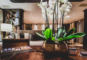 orchid on coffee table in main salon of charter yacht VERTIGE