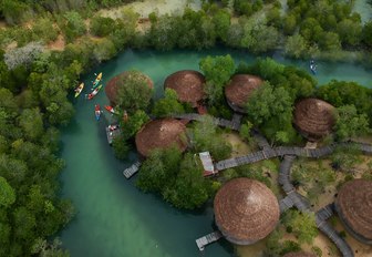 family on holiday kayaking on a river outlined by mangrove trees in a small village in the Us Virgin Islands 