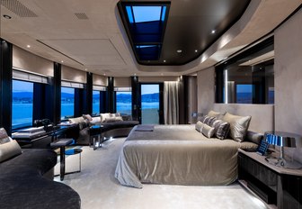 large bed faces panoramic windows in the master suite aboard charter yacht SOLO