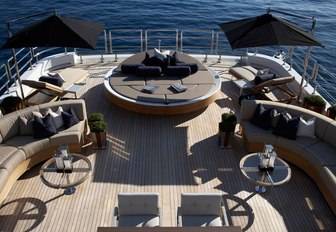 The spacious aft sundeck of charter yacht SEALYON with luxurious and curvaceous sunpads and loungers