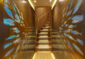 walls inlaid with fish shapes in corridor on the lower deck of charter yacht SOLIS 