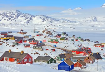 colourful houses surrounded by snow in Greenland