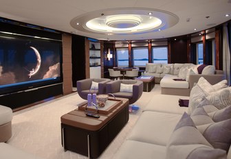 Cinema room with white sofas and wide screen TV on board charter yacht DREAM