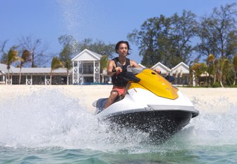 A man on a jet ski near Thanda Island, Indian Ocean