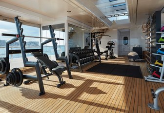 glass-enclosed gym with Technogym equipment on board luxury yacht JOY