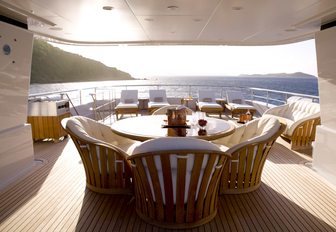 al fresco dining table under the radar arch on the sundeck of charter yacht HARLE 